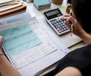 Asian woman working through paperwork