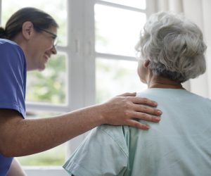 Nurse taking care of an old woman